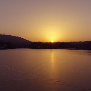 Sunset over frozen lake