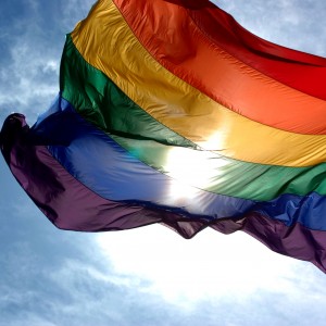 Rainbow_flag_and_blue_skies